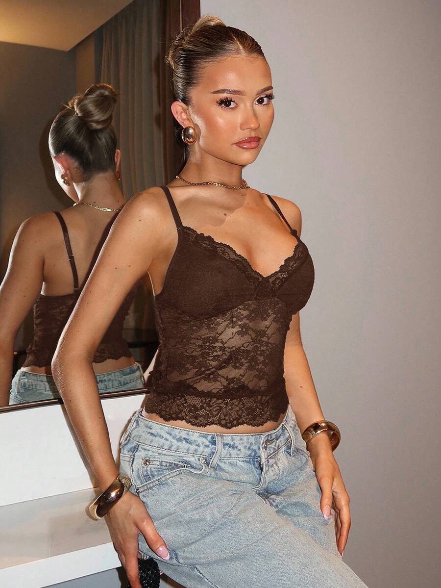 Black floral lace cropped camisole top for women featuring delicate spaghetti straps, cup detail, and semi-sheer contrast lace.