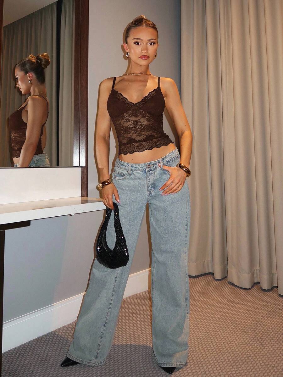 Black floral lace cropped camisole top for women featuring delicate spaghetti straps, cup detail, and semi-sheer contrast lace.
