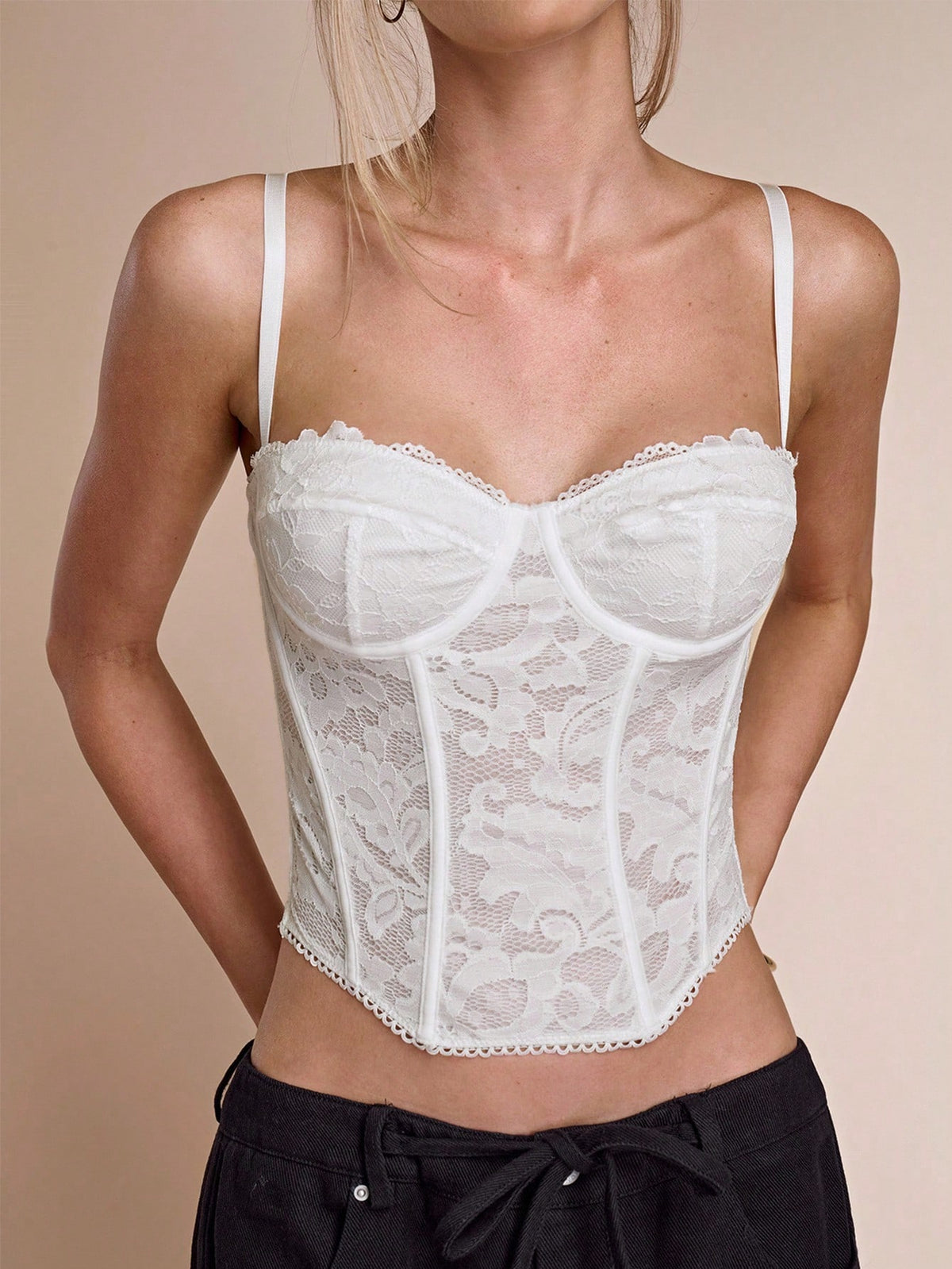 Black women’s lace cami top with spaghetti straps, contrast lace details, and an asymmetrical hem, styled as a slim-fit lined casual top.