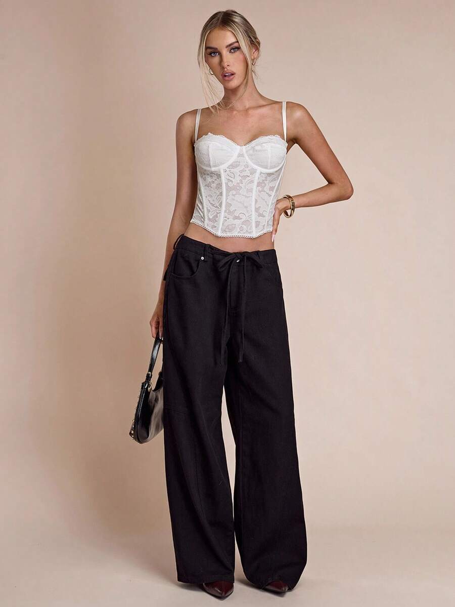 Women’s camisole top with cup detail, spaghetti straps, lined body, and slim fit design in knitted fabric with an asymmetrical hem.