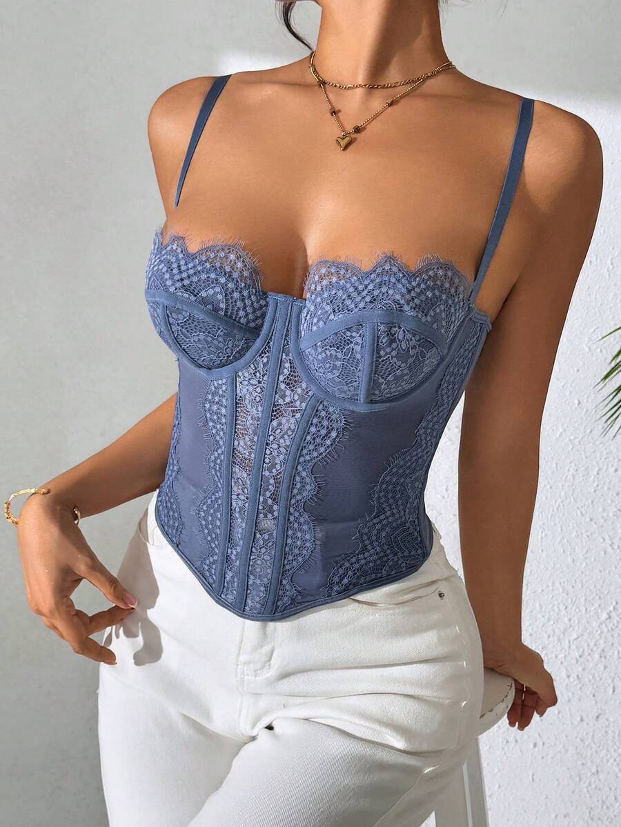 Front view of a black seamless lace camisole crop top featuring delicate spaghetti straps and intricate contrast lace detailing.