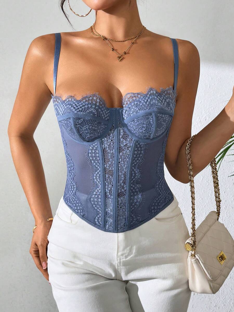 Front view of a black seamless lace camisole crop top featuring delicate spaghetti straps and intricate contrast lace detailing.