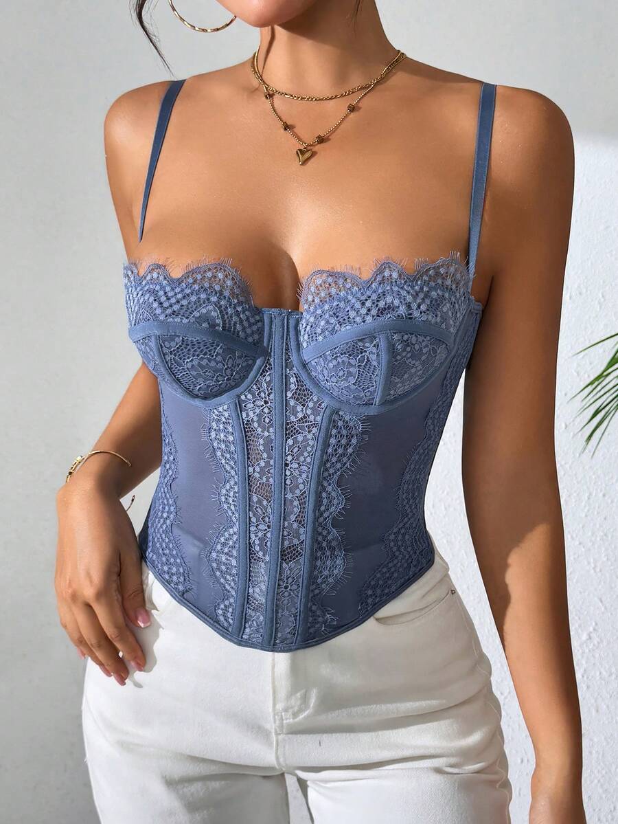 Front view of a black seamless lace camisole crop top featuring delicate spaghetti straps and intricate contrast lace detailing.