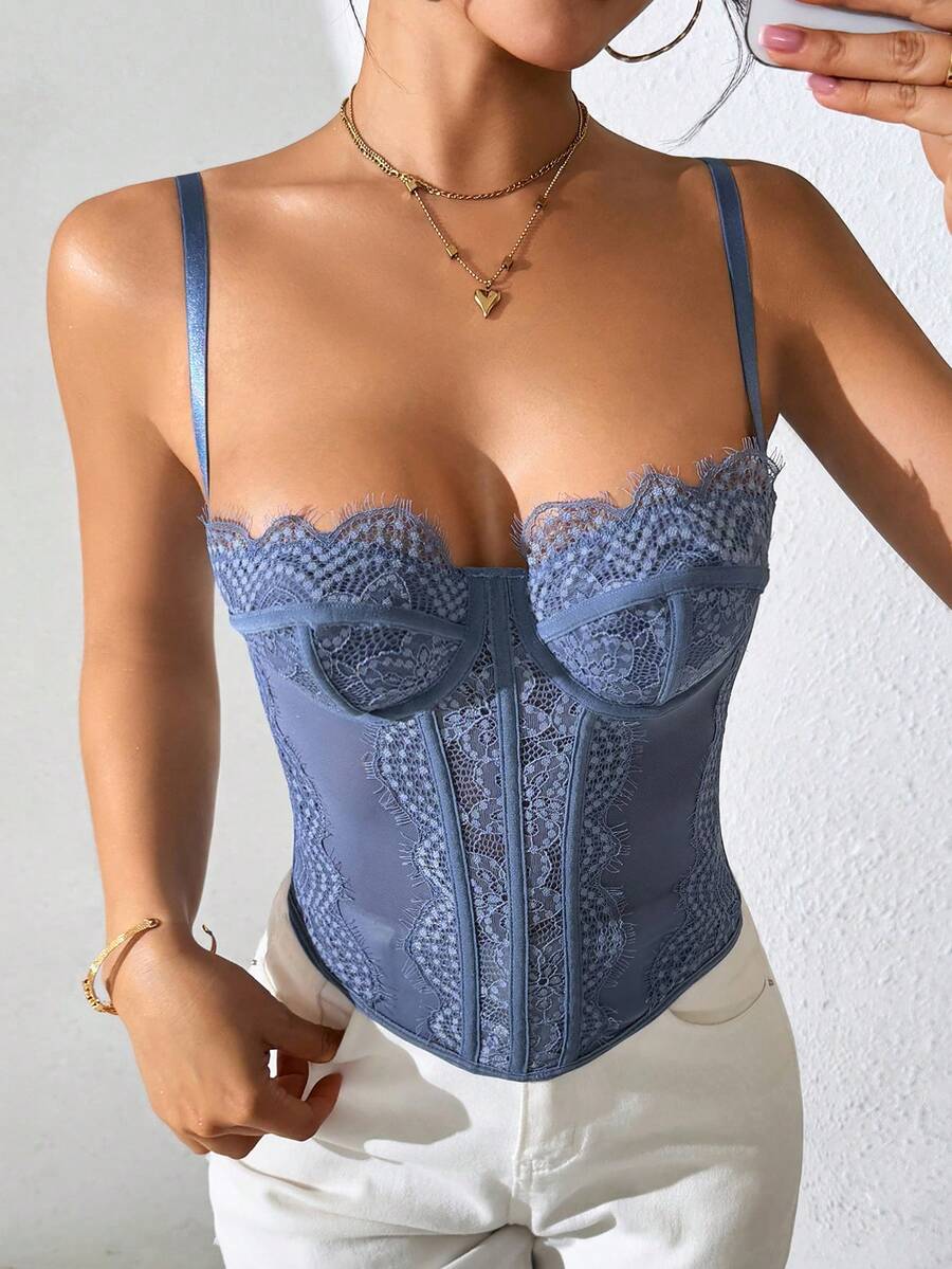 Front view of a black seamless lace camisole crop top featuring delicate spaghetti straps and intricate contrast lace detailing.