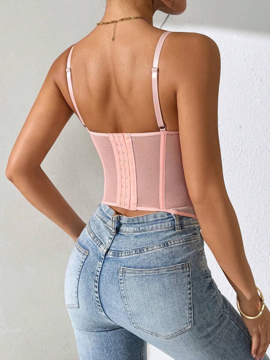Front view of a black seamless lace camisole crop top featuring delicate spaghetti straps and intricate contrast lace detailing.