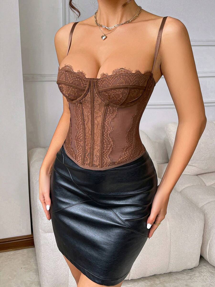 Front view of a black seamless lace camisole crop top featuring delicate spaghetti straps and intricate contrast lace detailing.