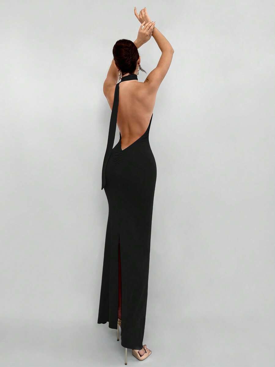Women's backless halter maxi dress featuring a split thigh, knot detail, slim fit silhouette, and elegant mid-waist cut.