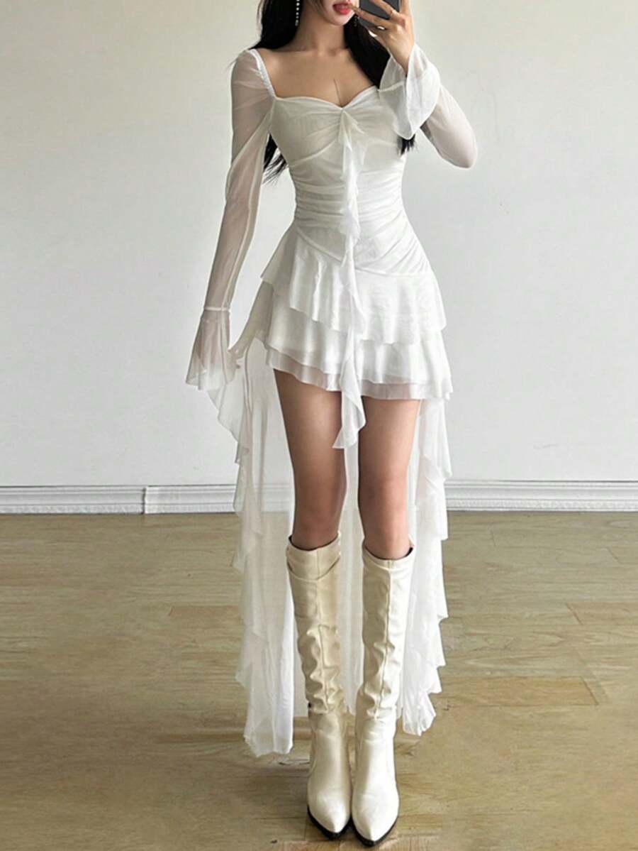 Woman wearing a solid off-the-shoulder asymmetrical midi dress with long flare sleeves.