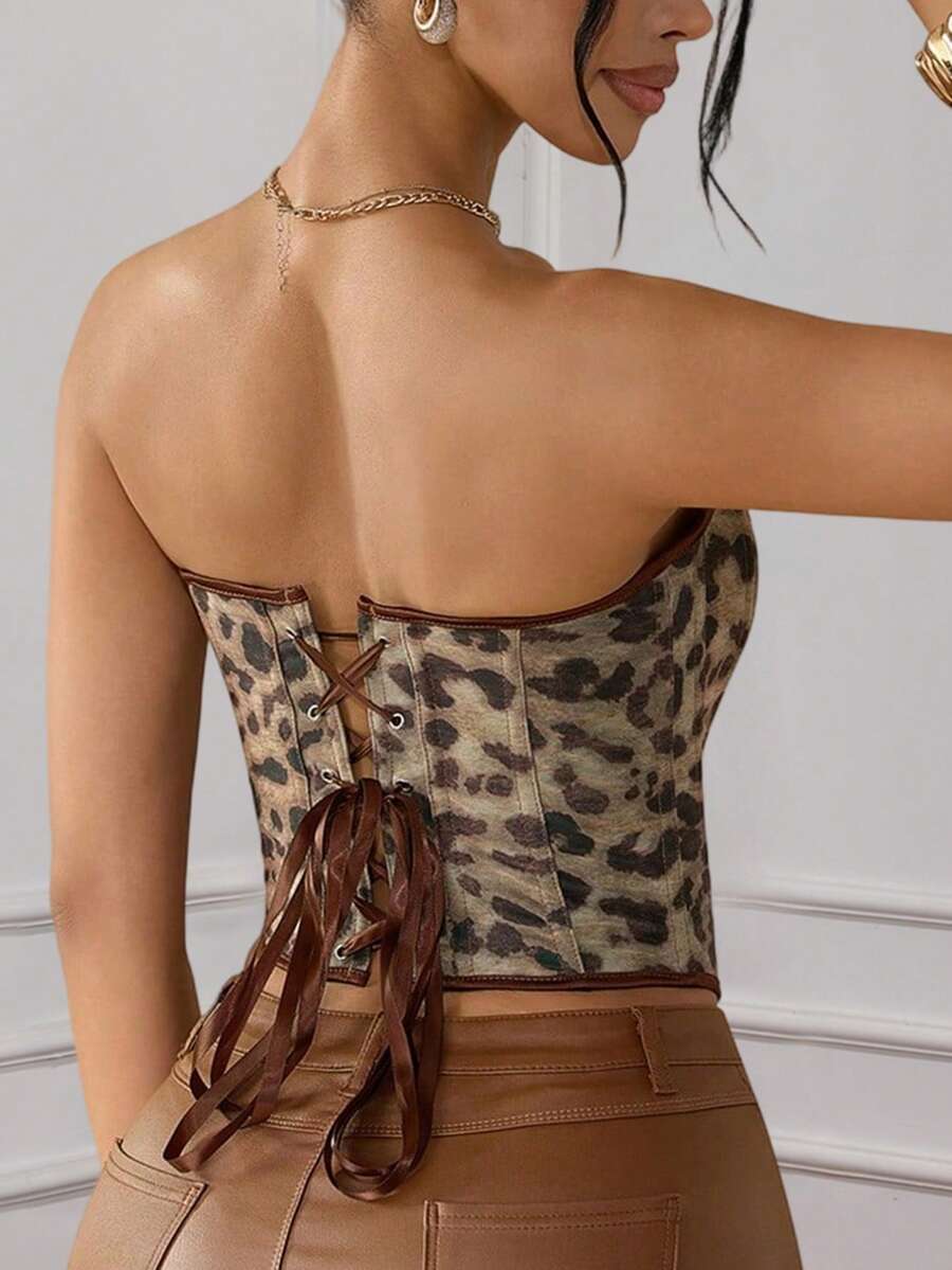 Front view of brown leopard print strapless waist cincher crop top featuring front lace-up detail with metal eyelets and asymmetrical hem for women.