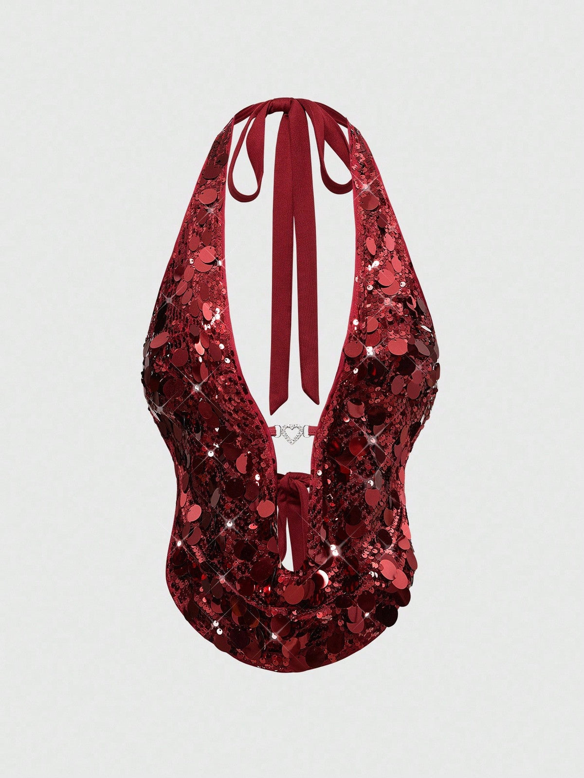 A woman wearing a burgundy sequin halter camisole top featuring a backless asymmetrical design.