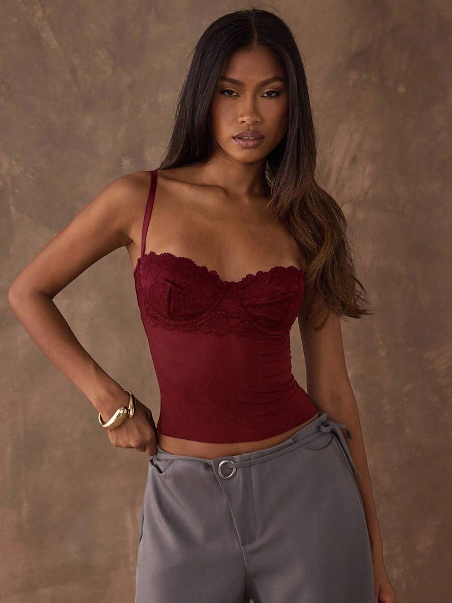 Women's black contrast lace camisole with spaghetti straps, cup detail, semi-sheer finish, and slim fit for going out or date night.