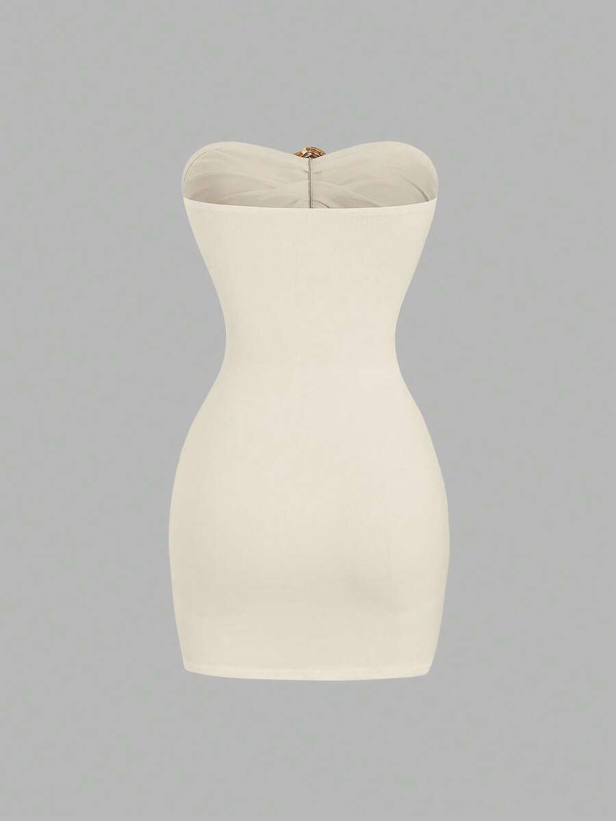 Women's black strapless bodycon mini dress featuring ruched detailing, cut-out design with ring accent, mid-waist pencil hem, and slim fit knitted stretch fabric.