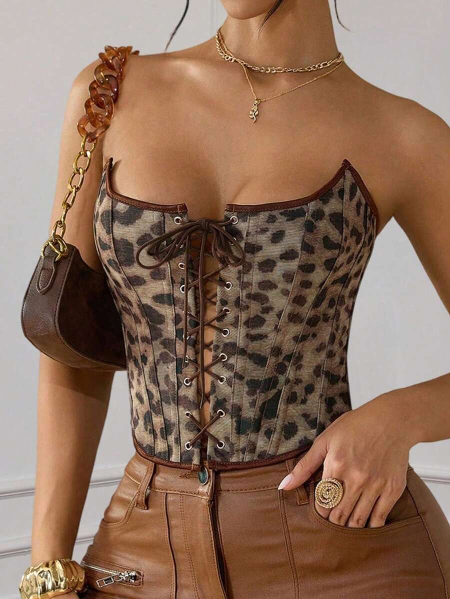 Front view of brown leopard print strapless waist cincher crop top featuring front lace-up detail with metal eyelets and asymmetrical hem for women.