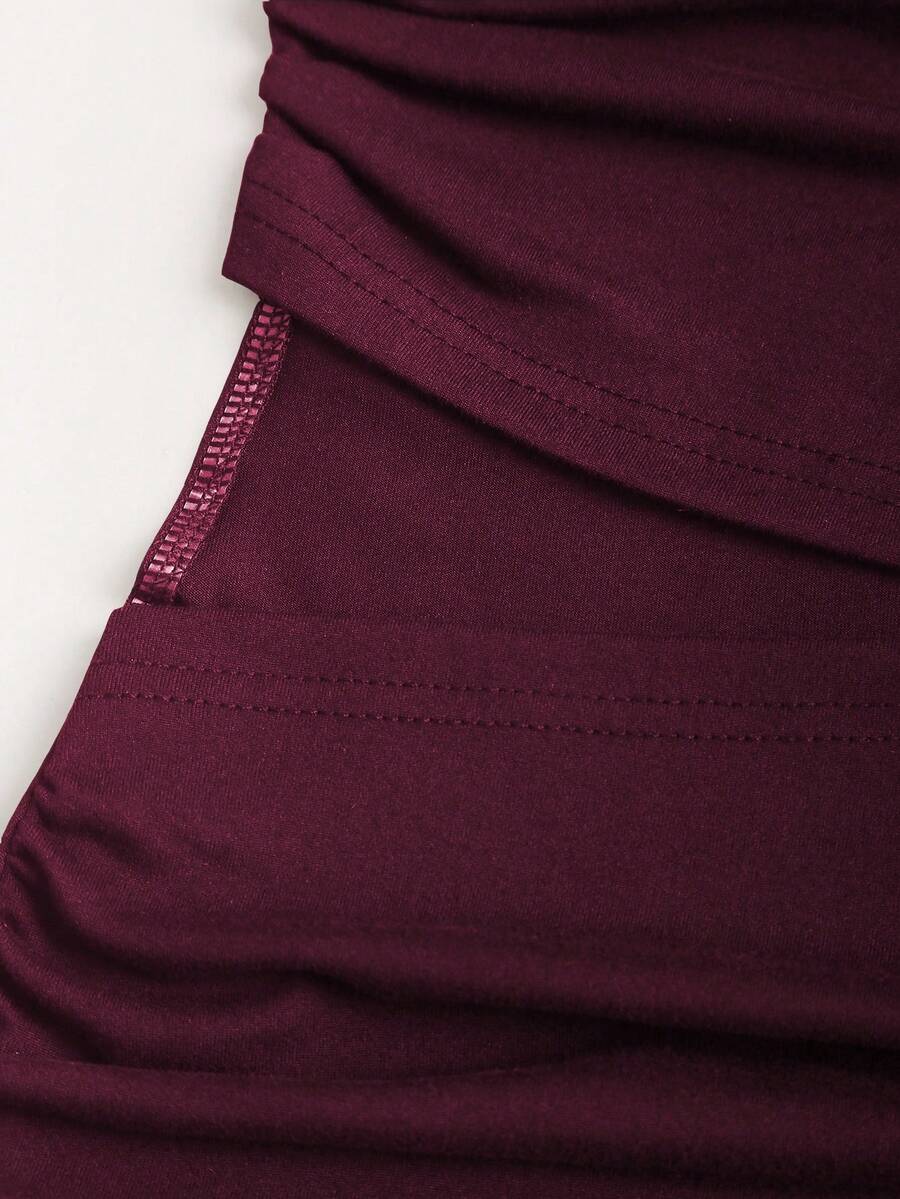 Women's black strapless bodycon mini dress featuring ruched detailing, cut-out design with ring accent, mid-waist pencil hem, and slim fit knitted stretch fabric.