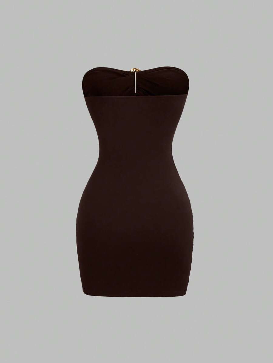 Women's black strapless bodycon mini dress featuring ruched detailing, cut-out design with ring accent, mid-waist pencil hem, and slim fit knitted stretch fabric.