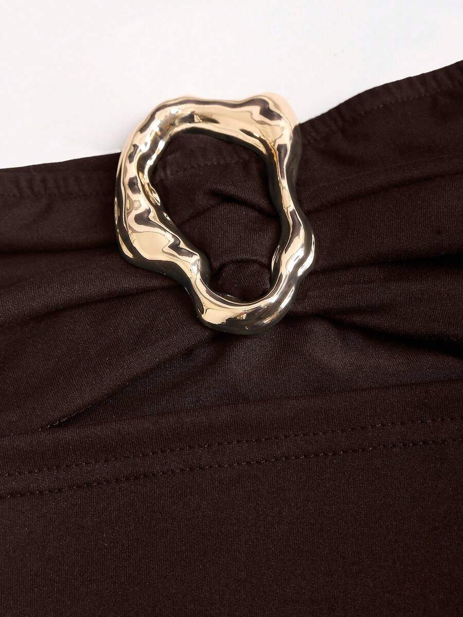 Women's black strapless bodycon mini dress featuring ruched detailing, cut-out design with ring accent, mid-waist pencil hem, and slim fit knitted stretch fabric.