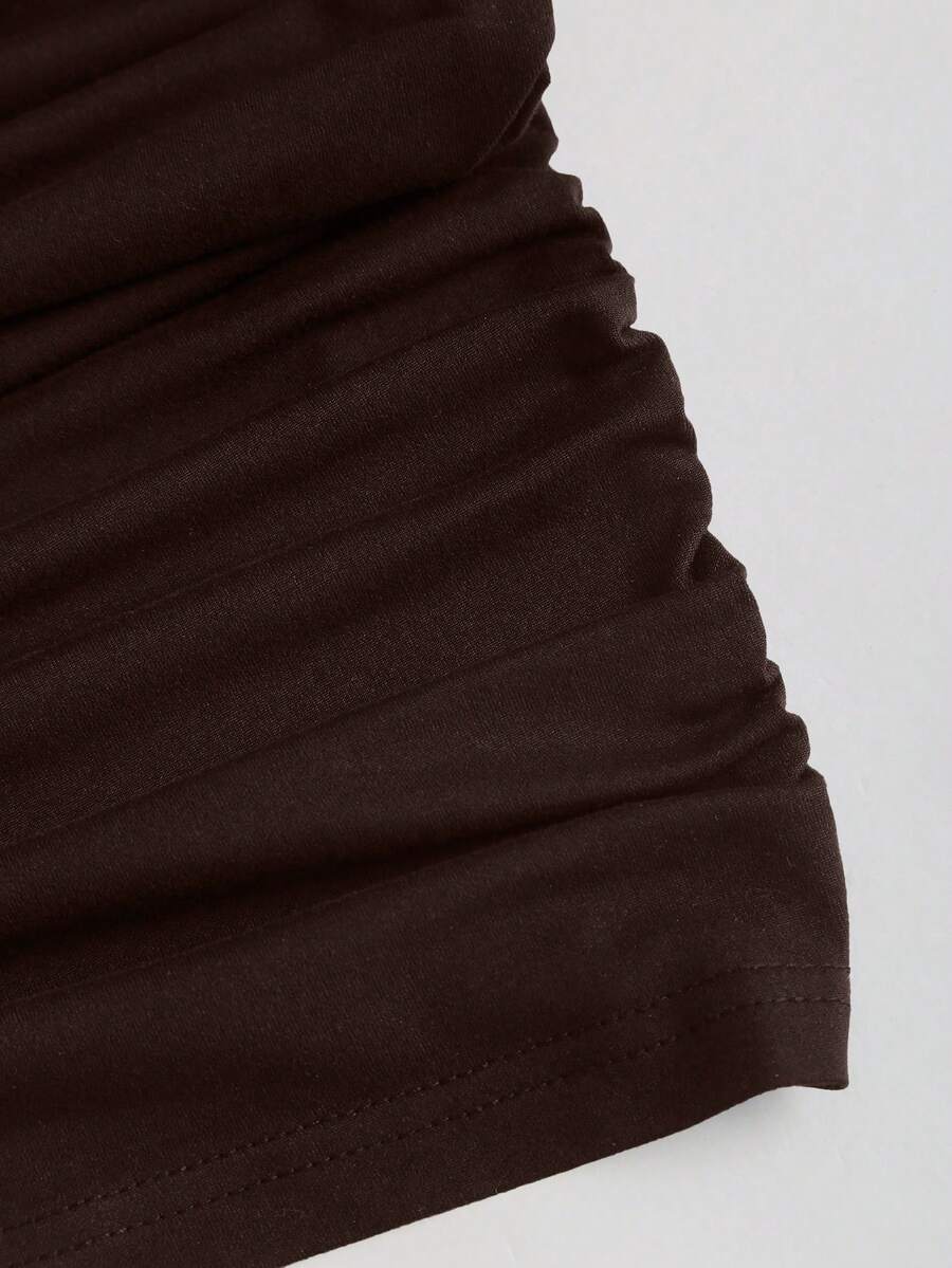 Women's black strapless bodycon mini dress featuring ruched detailing, cut-out design with ring accent, mid-waist pencil hem, and slim fit knitted stretch fabric.