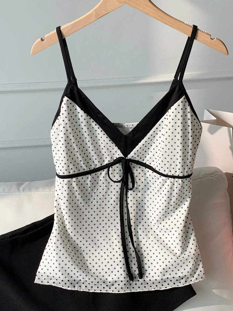 Black and white polka dot tie strap camisole top for women with thin spaghetti straps and slim fit.