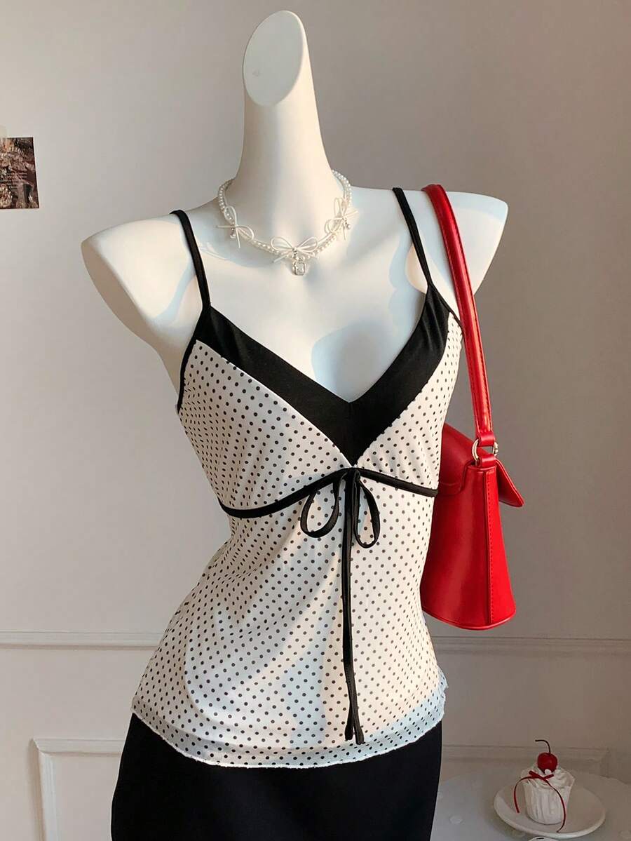 Black and white polka dot tie strap camisole top for women with thin spaghetti straps and slim fit.