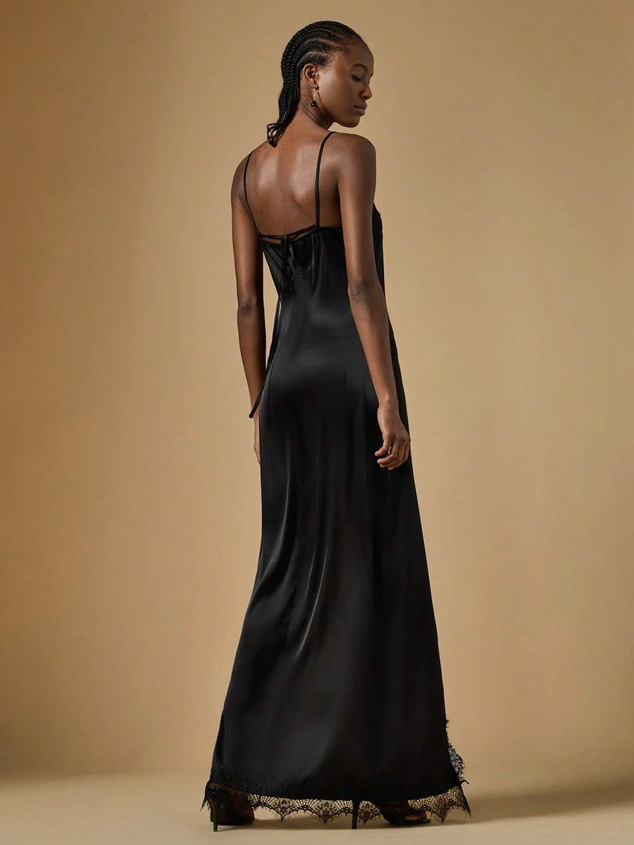 Women's black lace split satin long dress featuring spaghetti straps, asymmetrical slit hem, and matching arm sleeves.