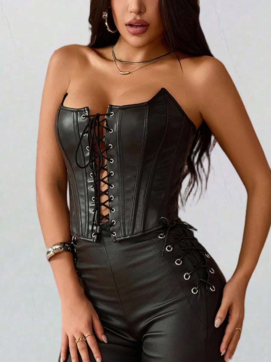 Black PU leather strapless bustier corset crop top featuring boned structure, lace-up grommet eyelets, and an asymmetrical hem on a women model.