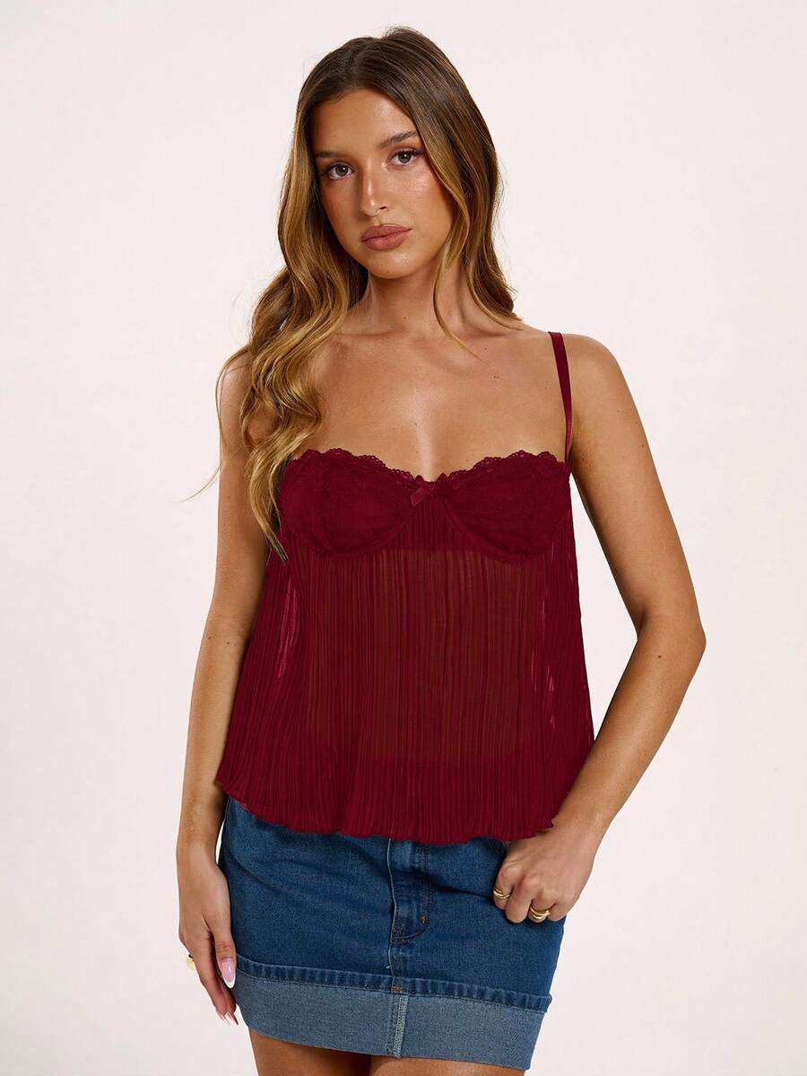 Black slim fit lace camisole corset top featuring lettuce trim flared hem, spaghetti straps, and unlined cup details.