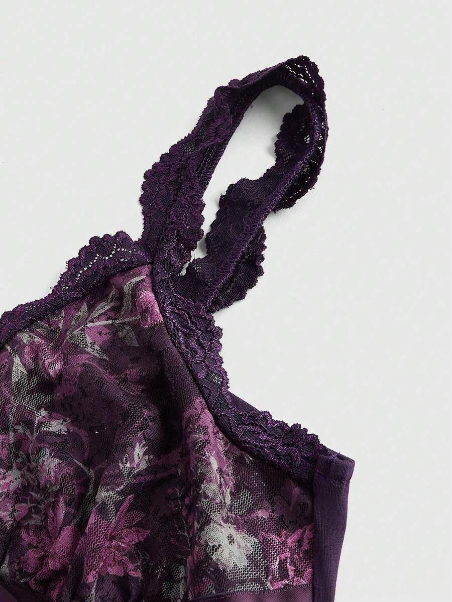 Women's black crop camisole top with rose pattern contrast lace, deep V-neck, and wide shoulder straps.