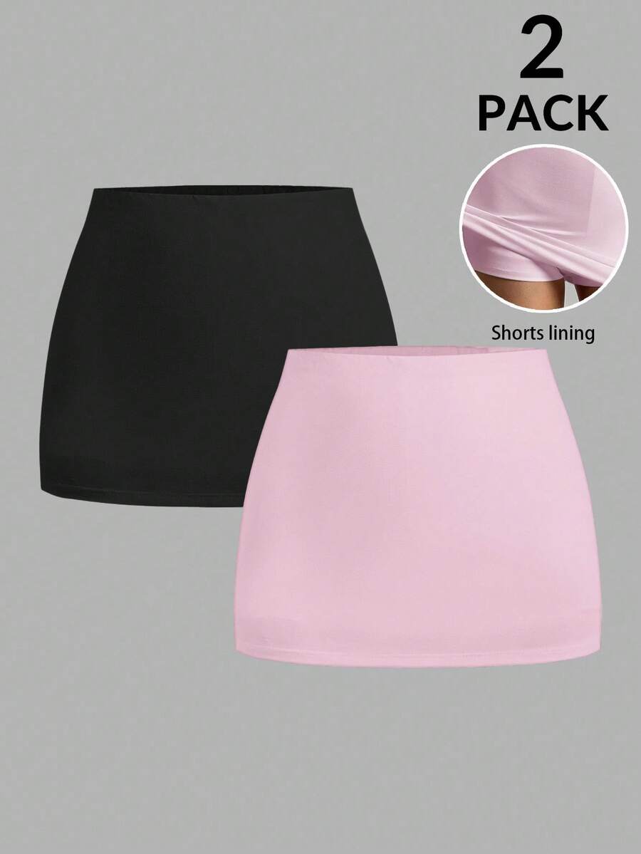 Women's black casual low rise bodycon mini skort with built-in shorts in knitted plain stretch fabric.