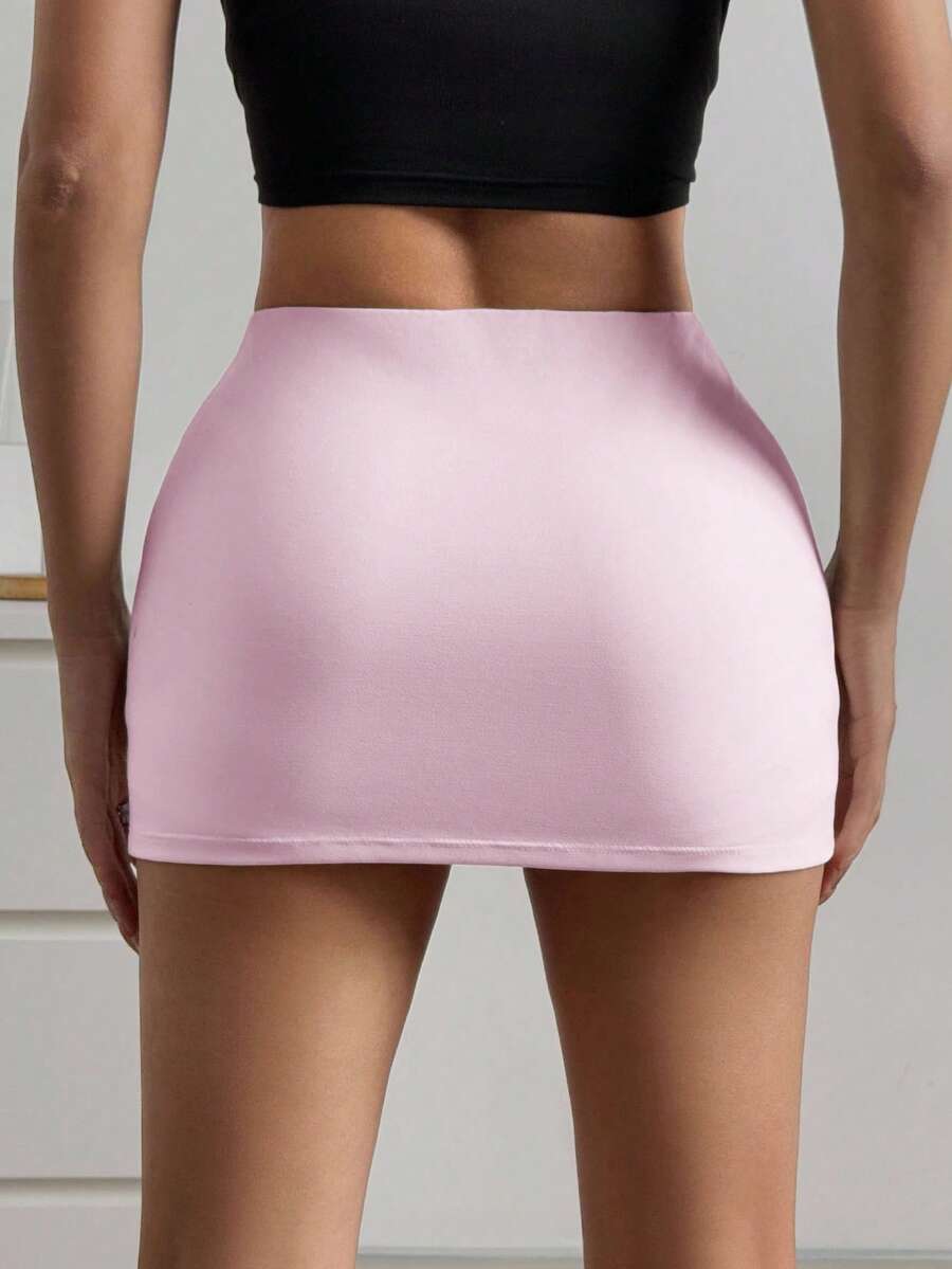 Women's black casual low rise bodycon mini skort with built-in shorts in knitted plain stretch fabric.