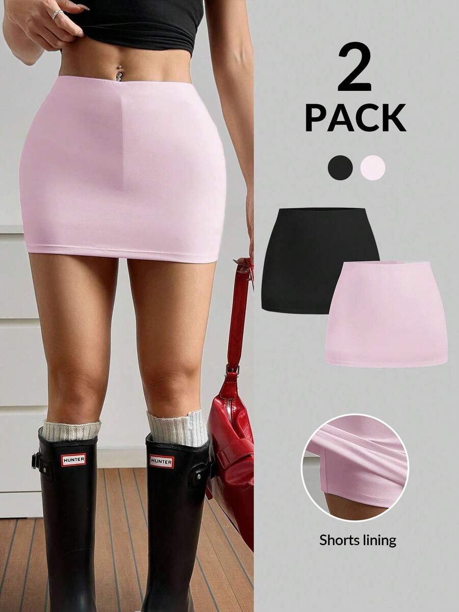 Women's black casual low rise bodycon mini skort with built-in shorts in knitted plain stretch fabric.