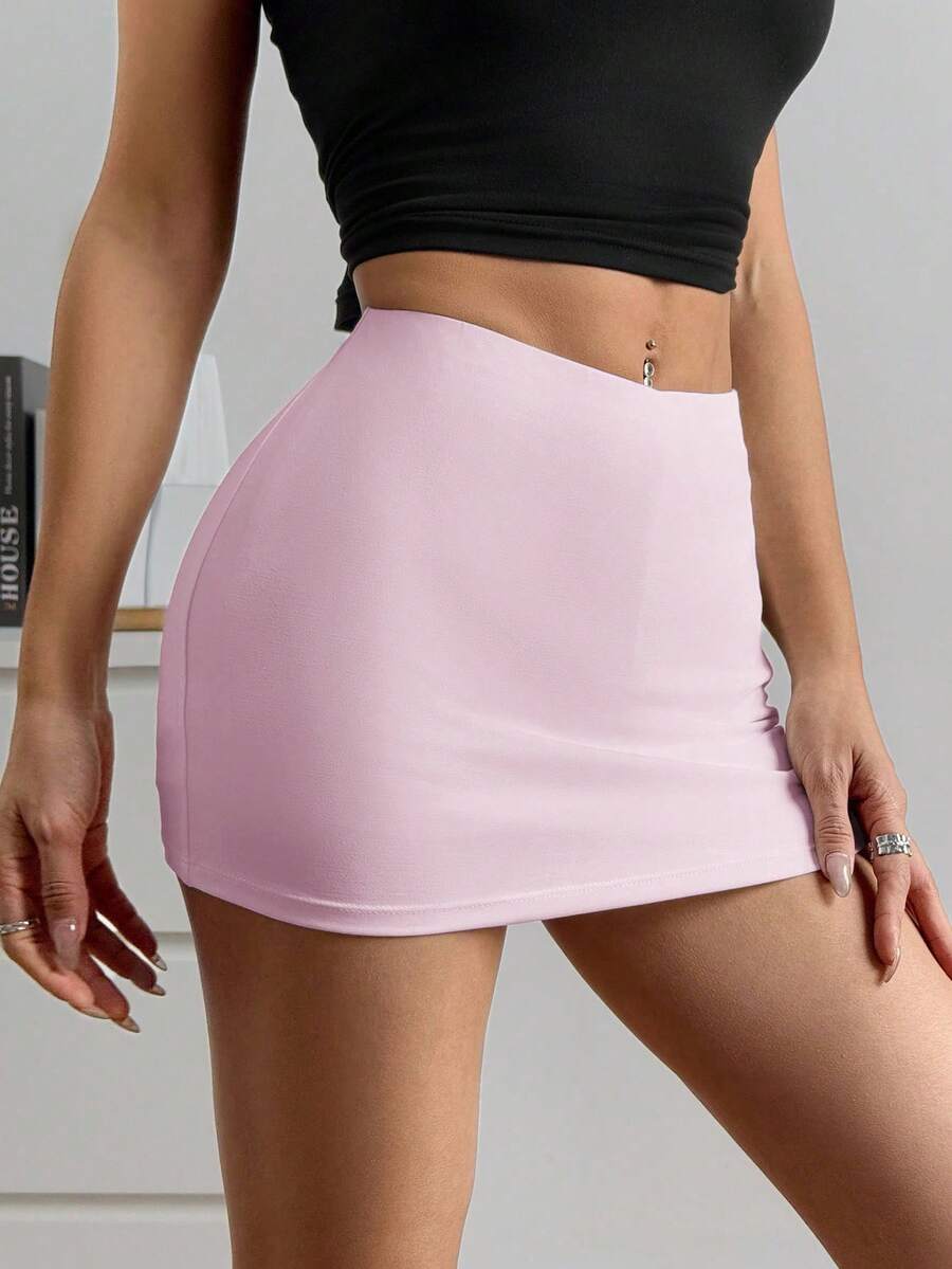 Women's black casual low rise bodycon mini skort with built-in shorts in knitted plain stretch fabric.