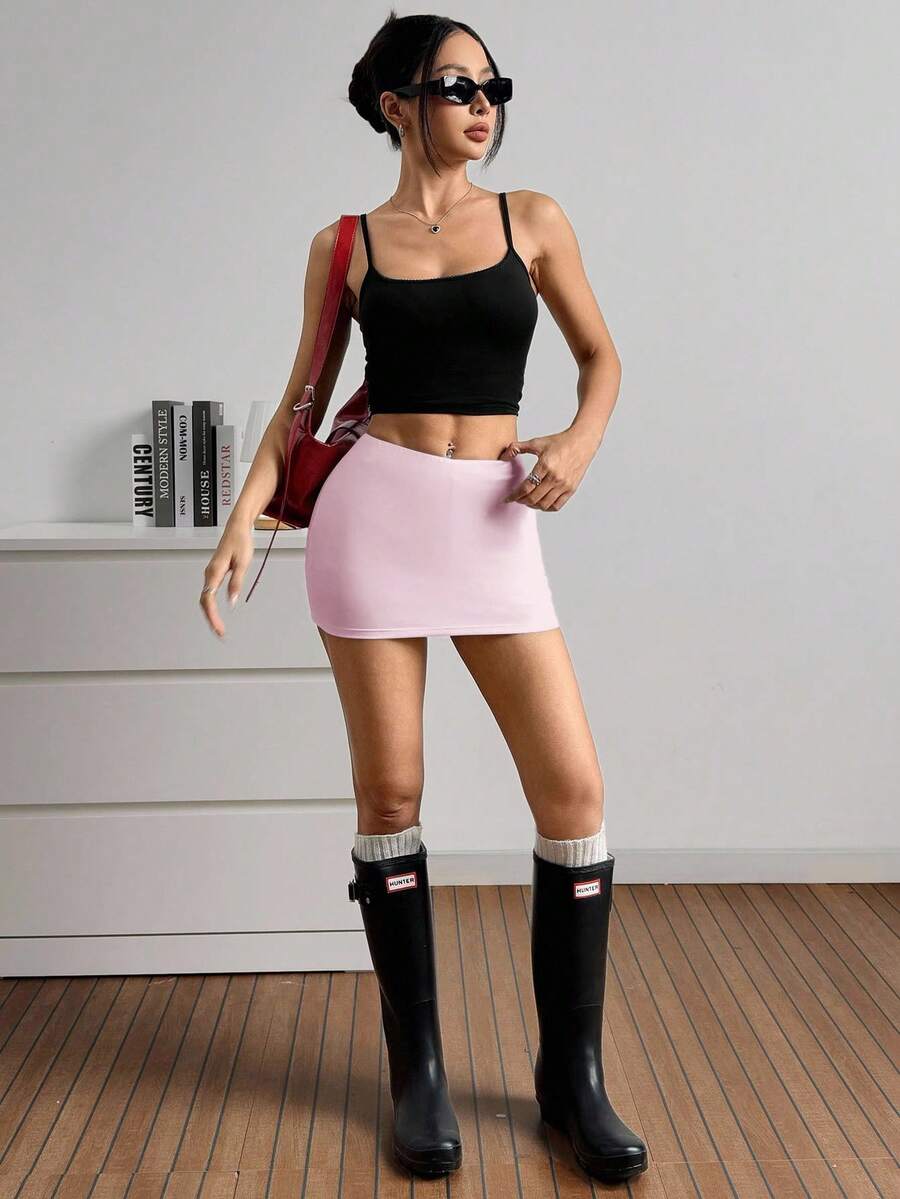 Women's black casual low rise bodycon mini skort with built-in shorts in knitted plain stretch fabric.