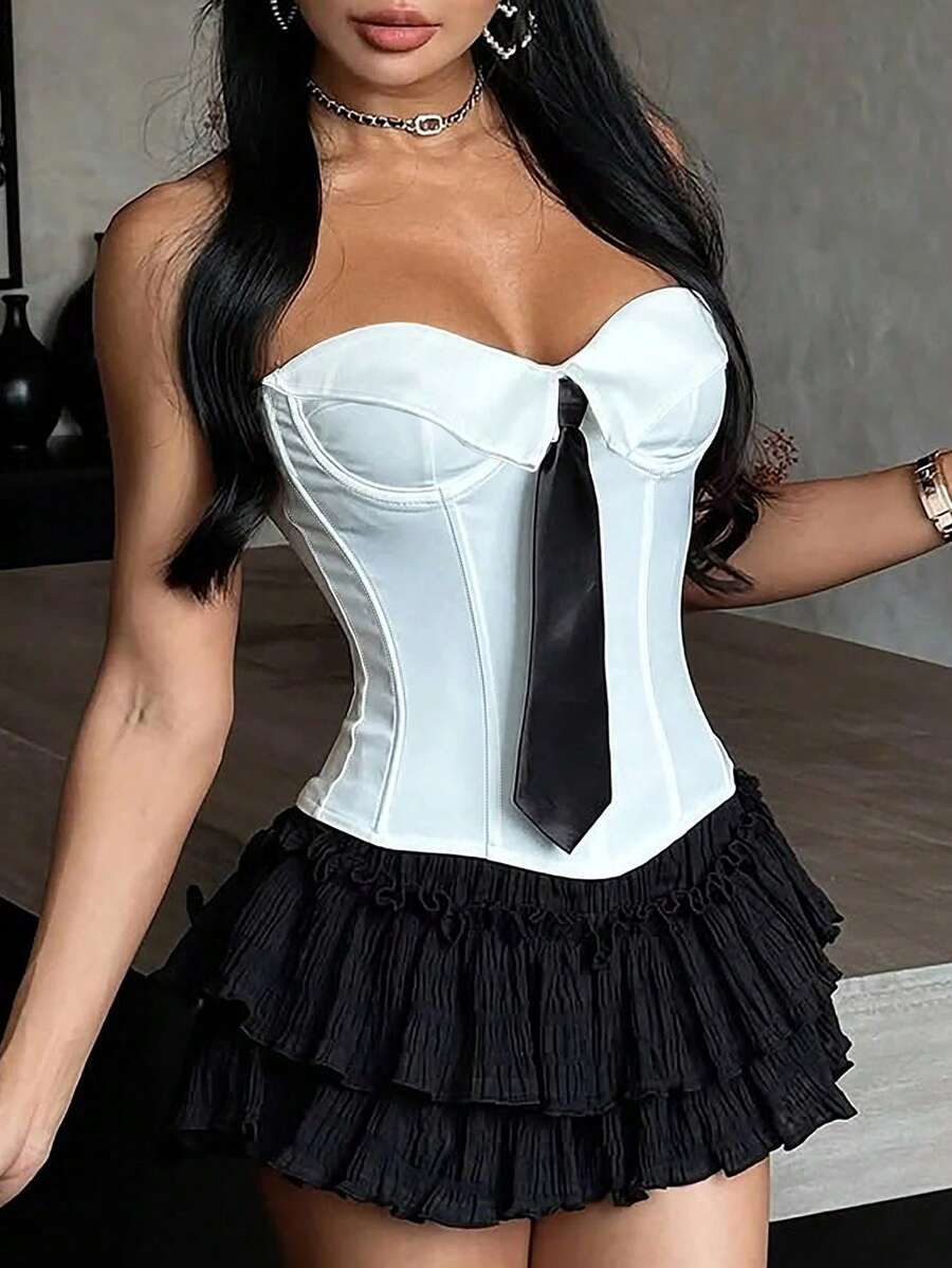 Women's white cropped tube top featuring a strapless backless design and asymmetrical hem in a slim fit style.