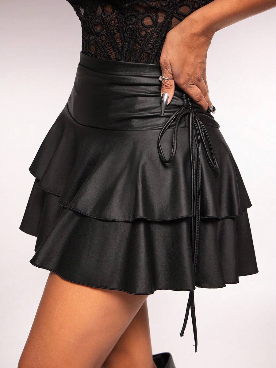 Women's black PU coated layered ruffle mini skirt featuring a high waist, tiered ruffle hem, and zipper detail.