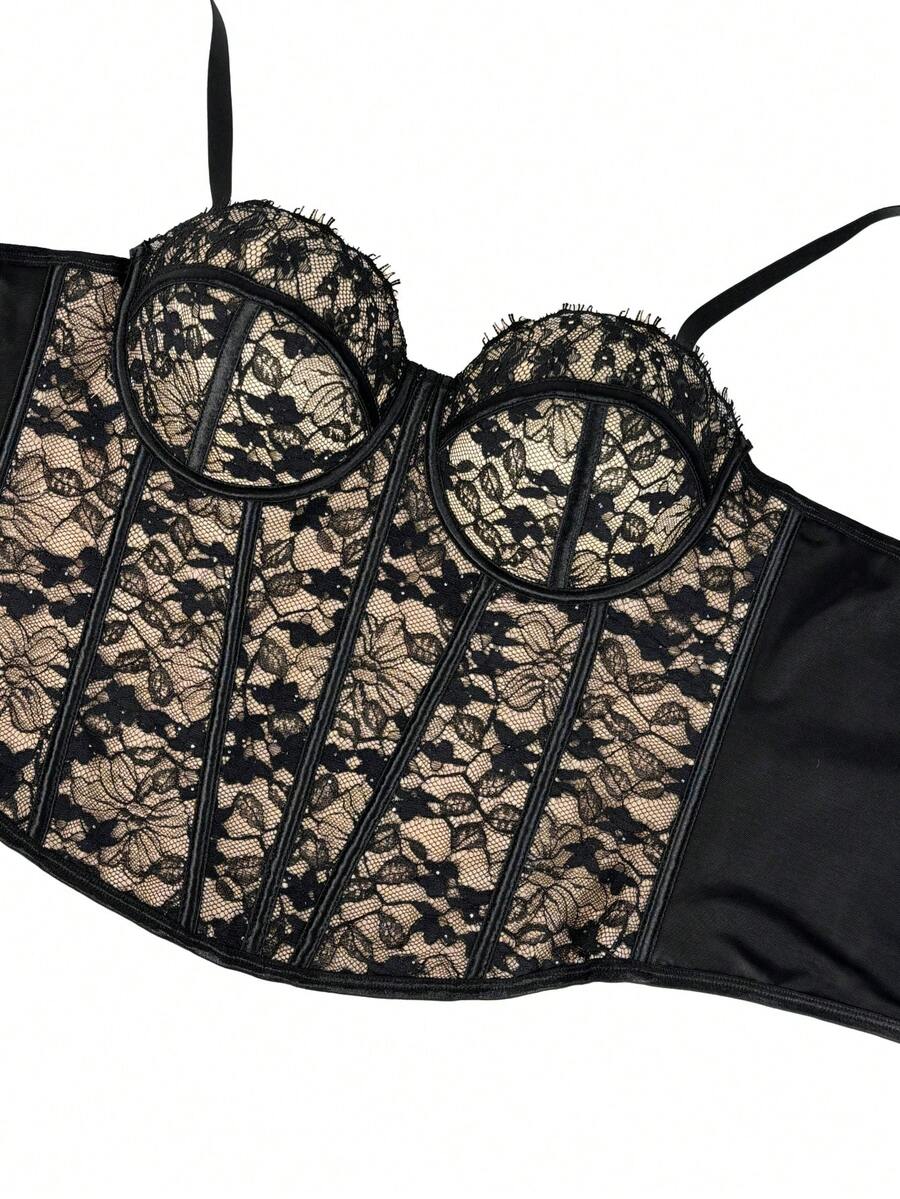 Black women's shaping cami with contrast lace, spaghetti straps, asymmetrical hem, lined body, and slim fit for casual and night-out styling.