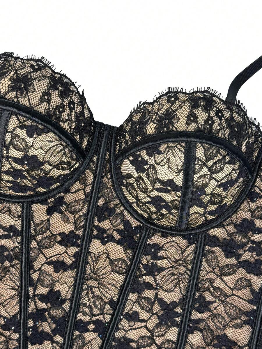 Black women's shaping cami with contrast lace, spaghetti straps, asymmetrical hem, lined body, and slim fit for casual and night-out styling.