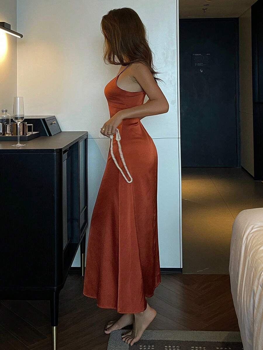 Red backless long satin slip nightgown for women featuring spaghetti straps and a slim fit sleeveless design.