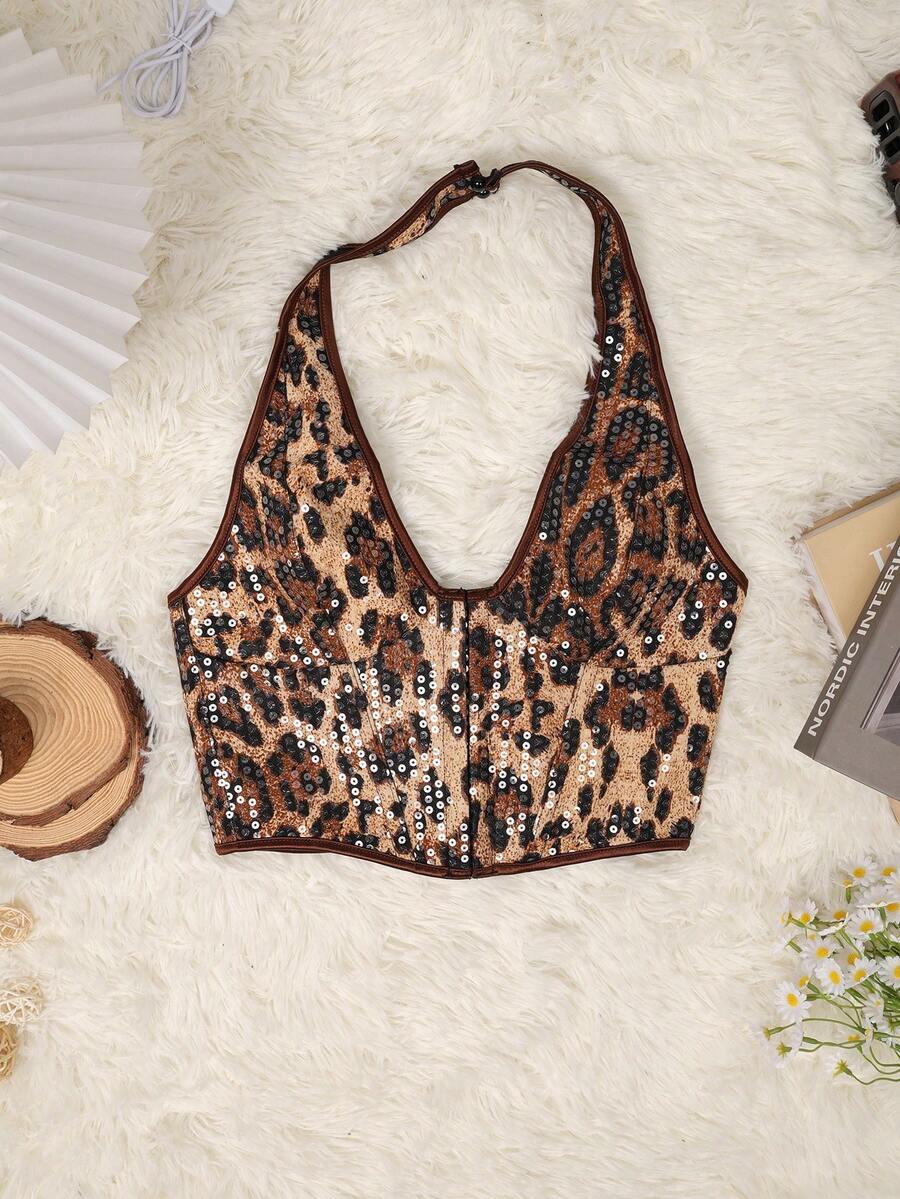 Women's leopard print backless halter crop top featuring front grommet lace-up detailing and slim fit crop silhouette.