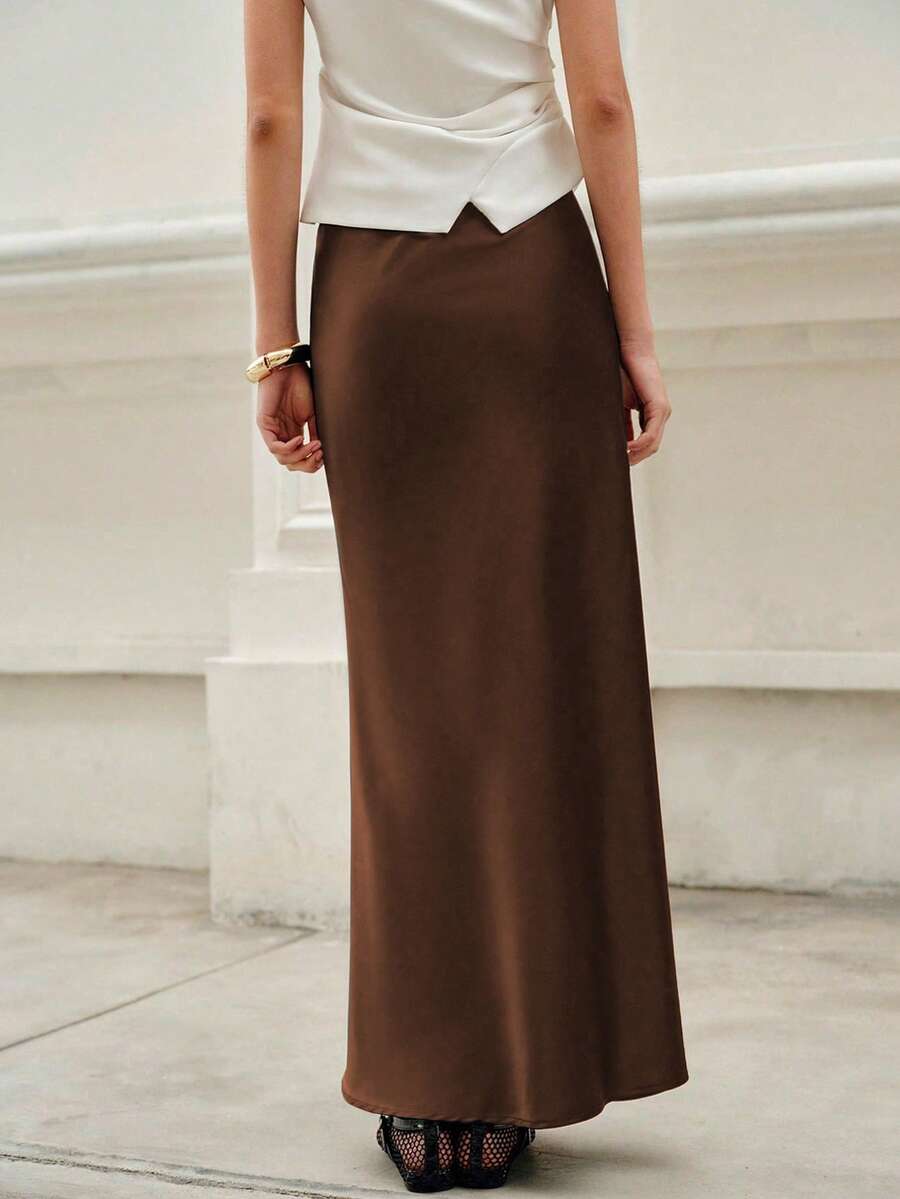 Elegant plain black mid waist long satin skirt for women featuring a sleek zipper closure and regular fit.