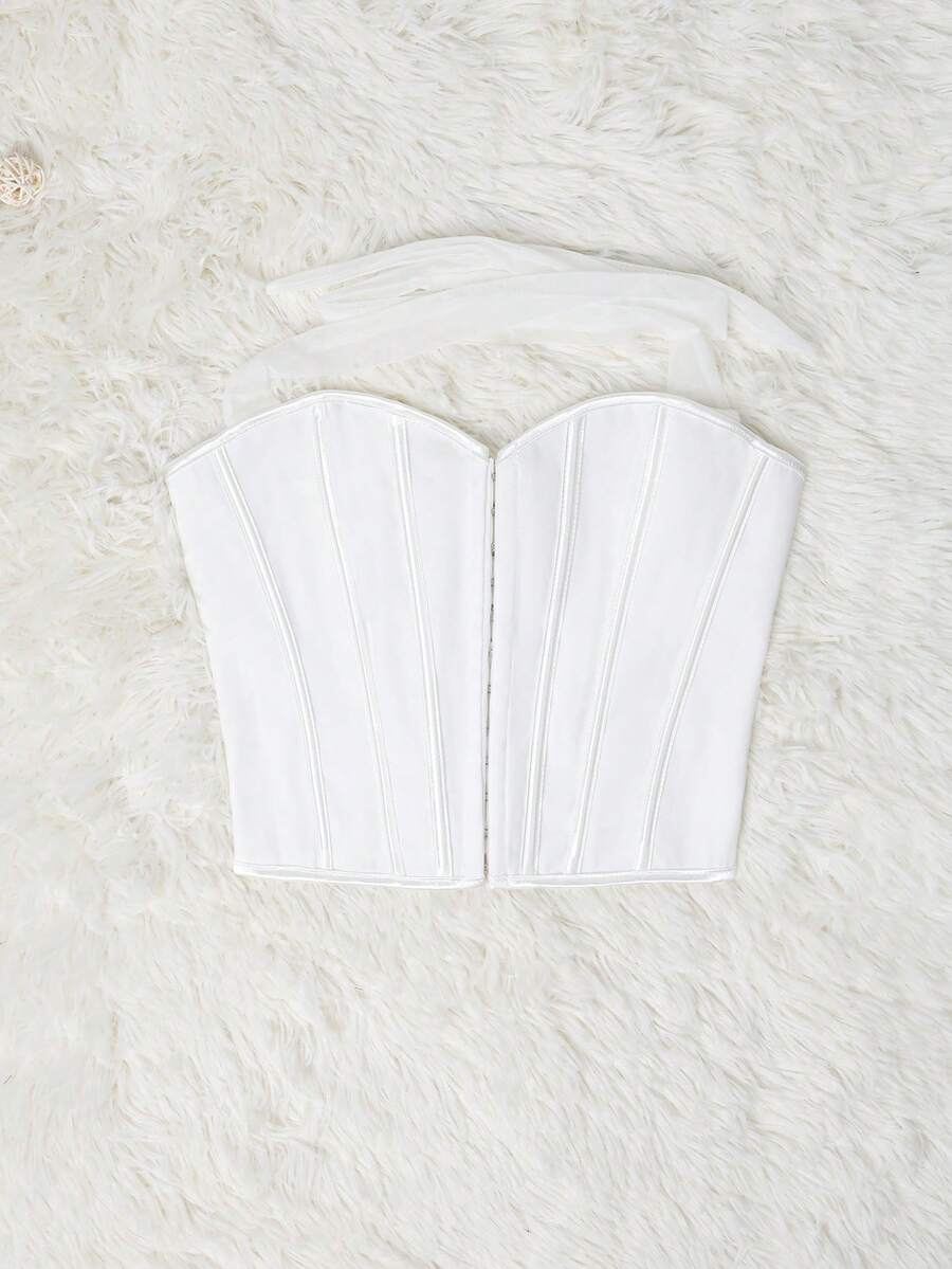 White Y2K halter backless corset top featuring lace-up back detail and metal grommet eyelets for women