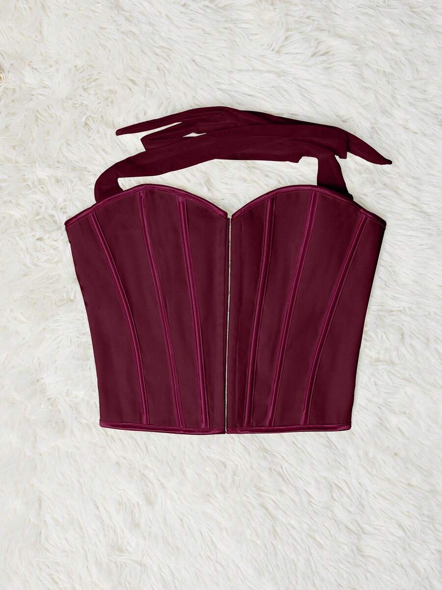 White Y2K halter backless corset top featuring lace-up back detail and metal grommet eyelets for women