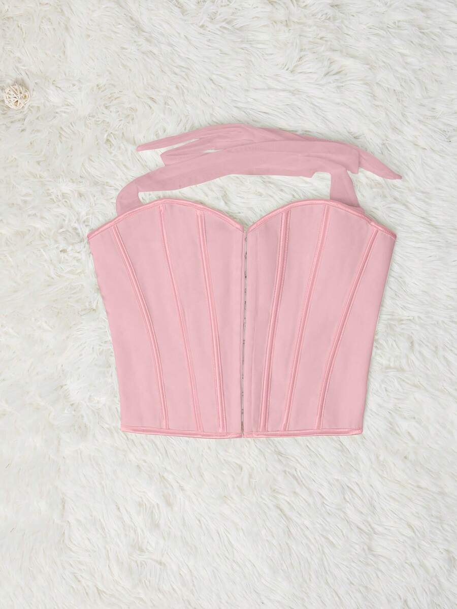 White Y2K halter backless corset top featuring lace-up back detail and metal grommet eyelets for women