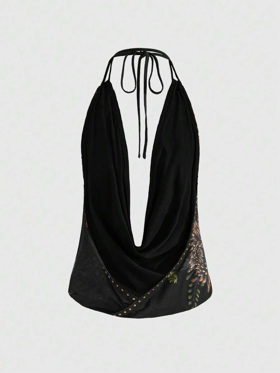 Women's black backless halter crop top featuring a V-neckline, tie-back detail, and asymmetrical hem.