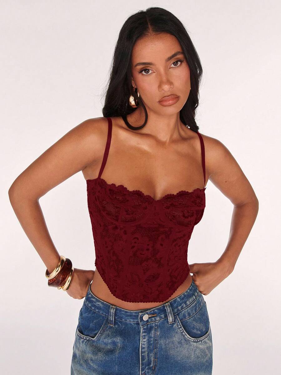 Black women’s lace cami top with spaghetti straps, contrast lace details, and an asymmetrical hem, styled as a slim-fit lined casual top.