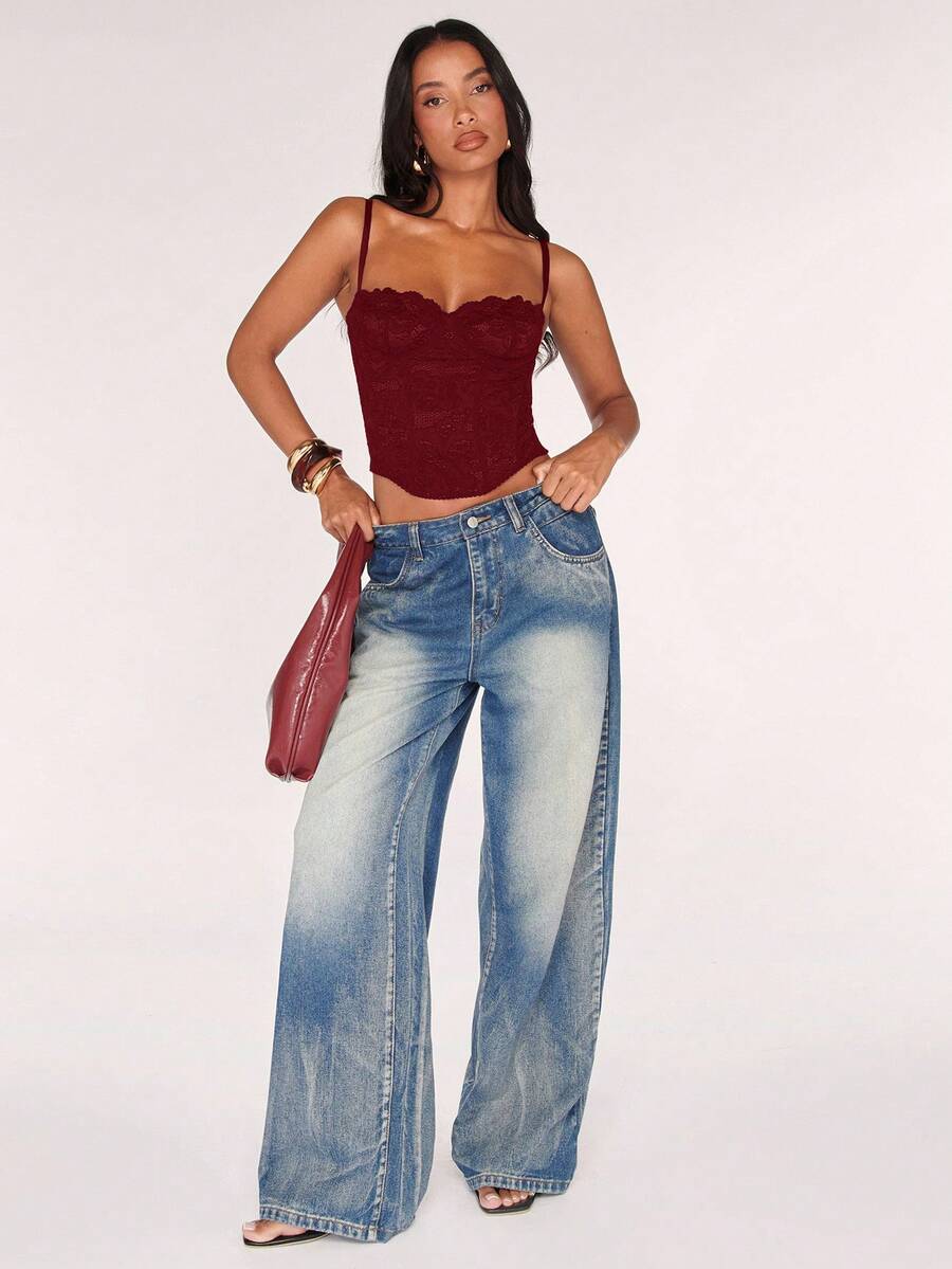 Black women’s lace cami top with spaghetti straps, contrast lace details, and an asymmetrical hem, styled as a slim-fit lined casual top.