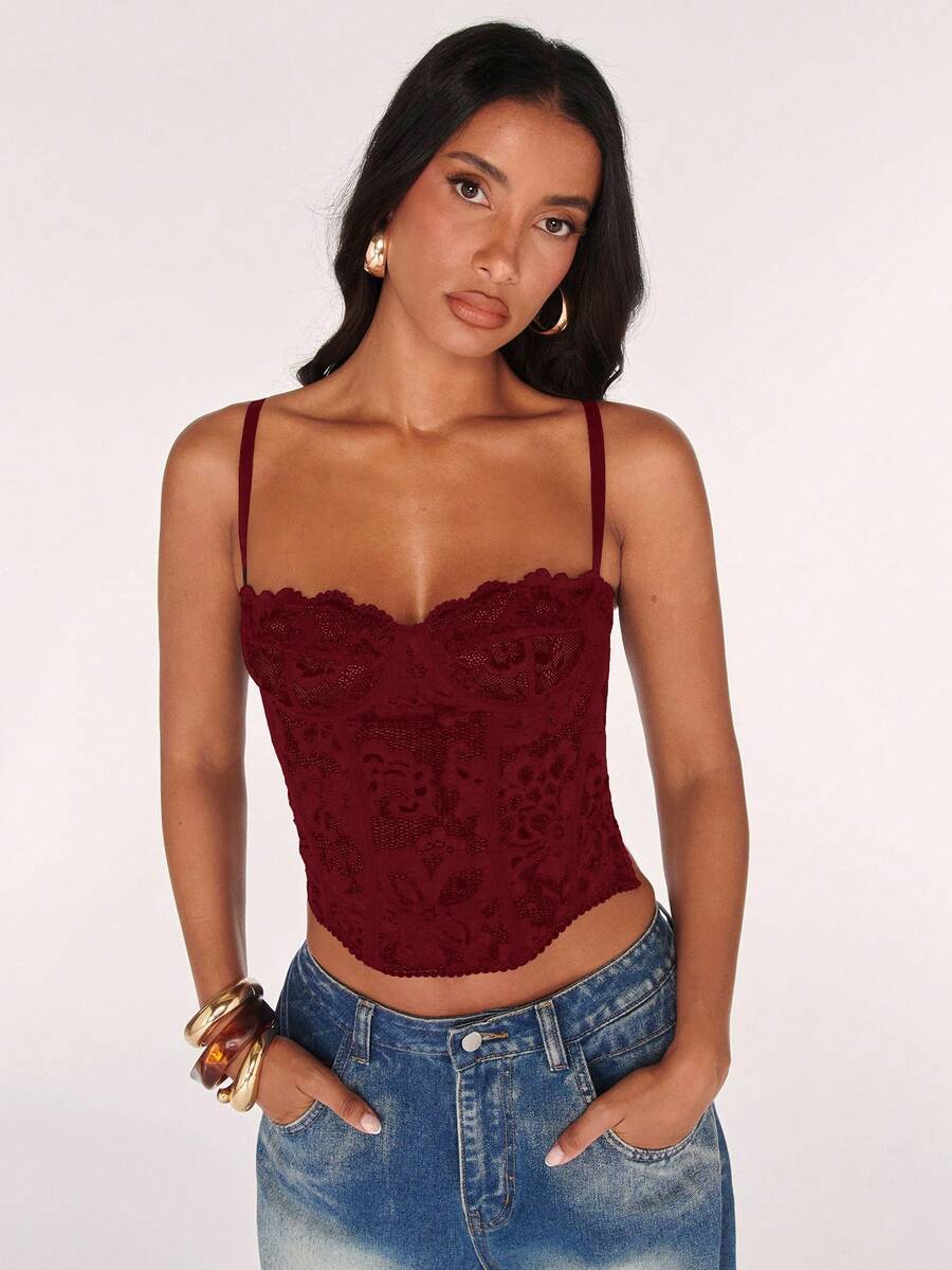 Black women’s lace cami top with spaghetti straps, contrast lace details, and an asymmetrical hem, styled as a slim-fit lined casual top.