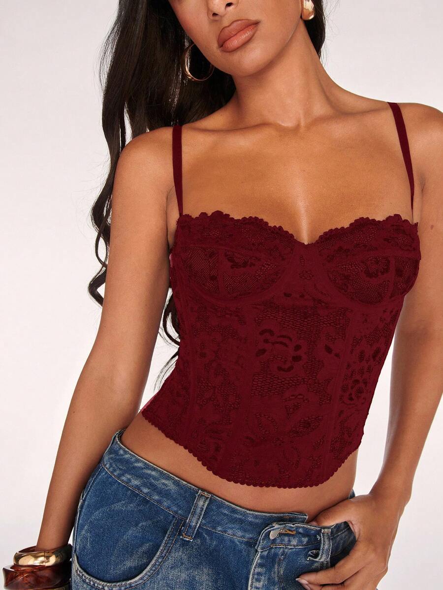 Black women’s lace cami top with spaghetti straps, contrast lace details, and an asymmetrical hem, styled as a slim-fit lined casual top.