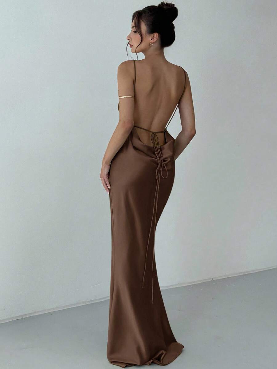 Beige satin backless maxi dress featuring criss-cross spaghetti straps and a mermaid hemline.