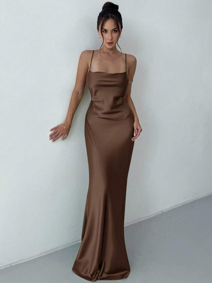 Beige satin backless maxi dress featuring criss-cross spaghetti straps and a mermaid hemline.