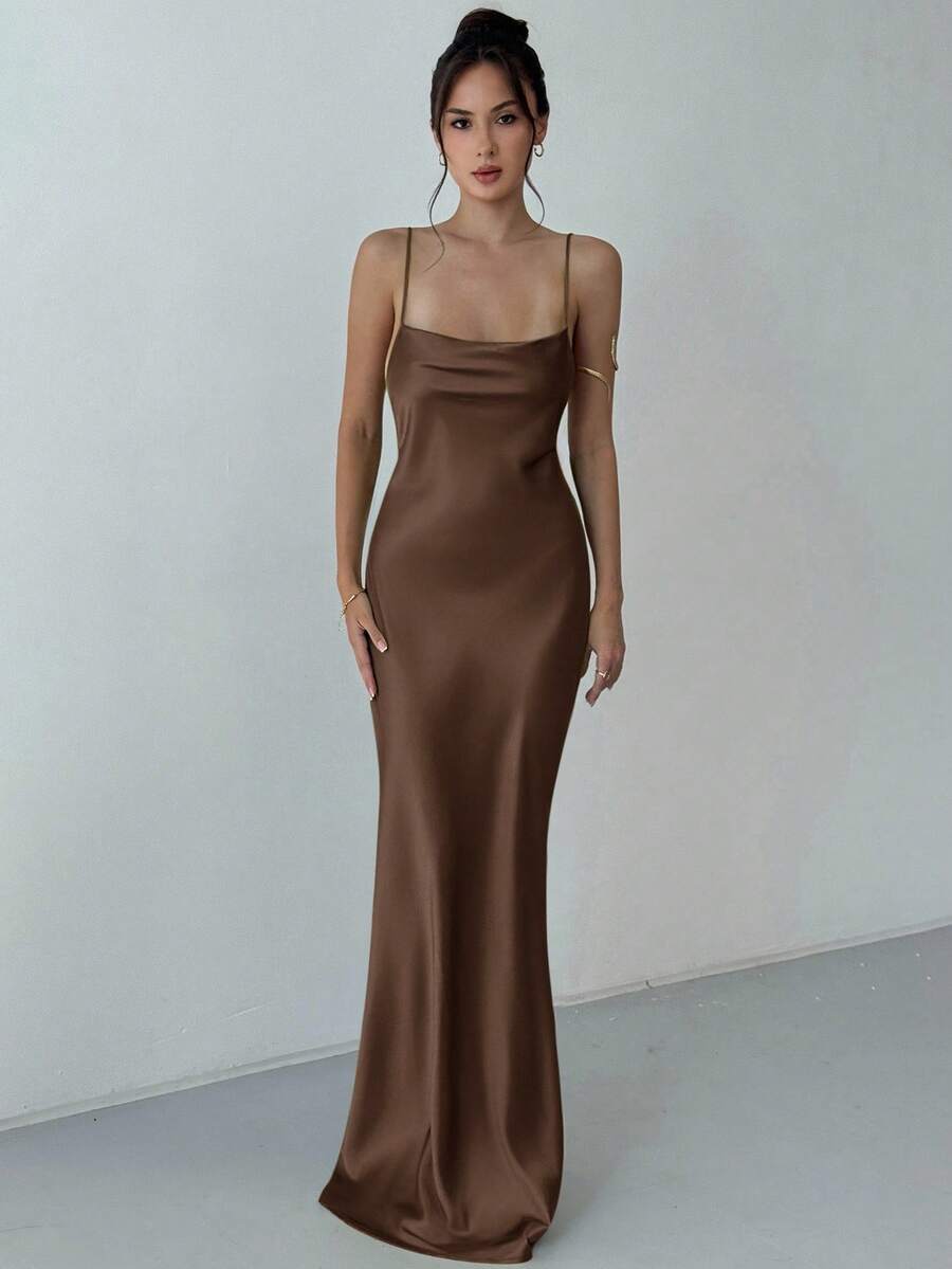 Beige satin backless maxi dress featuring criss-cross spaghetti straps and a mermaid hemline.